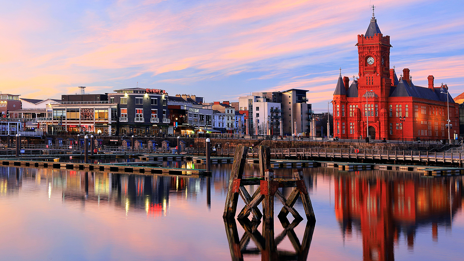 Image of Cardiff Bay with Mermaid Quay in background and water in foreground..
